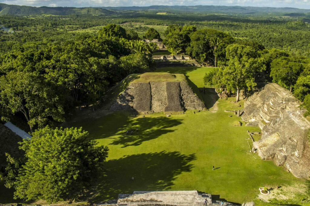 Ancient Maya temples surrounded by lush greenery at Xunantunich in Belize, highlighting cultural heritage and community spirit