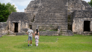 couple climbing the temples at Caracol Archaeological Site in Cayo, Belize