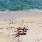 women relaxing on a sand bar in Belize