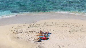 vrouwen die zich ontspannen op een zandbank in Belize